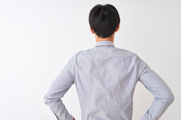 Chinese businessman wearing elegant tie standing over isolated white background standing backwards looking away with arms on body