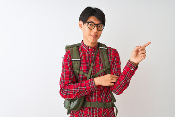 Chinese hiker man wearing backpack canteen glasses over isolated white background with a big smile on face, pointing with hand and finger to the side looking at the camera.