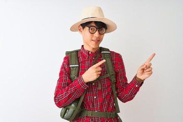 Chinese hiker man wearing backpack canteen glasses hat over isolated white background smiling and...