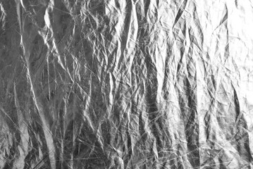 Silver wrinkled material. Background made of silver, wrinkled material.