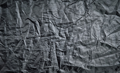 Black wrinkled material. A background made of black, wrinkled material