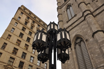 Fototapeta na wymiar Lamp post and buildings in a city square