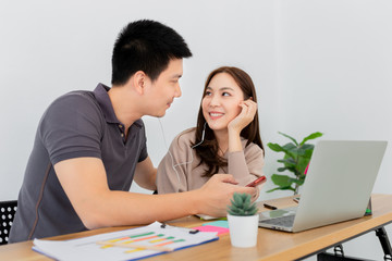 couple asian lover listening music with smartphone in romantic time, they feeling happy and smile, music streaming technology, lover in office