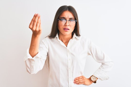 Young beautiful businesswoman wearing glasses standing over isolated white background Doing Italian gesture with hand and fingers confident expression