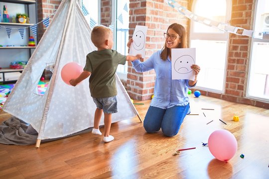 Young therapist woman speaking with child, counselor and behaviour correction at the office around toys