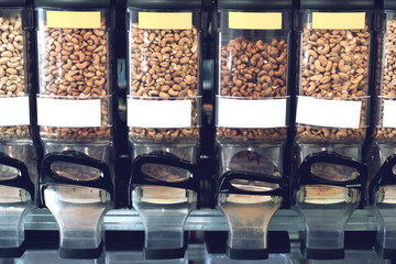 Dispensers with nuts in zero waste shop. New trend alternative buying.