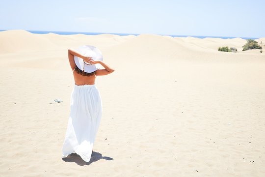 Young beautiful woman smiling happy enjoying summer vacation at maspalomas dunes beach