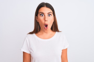 Fototapeta premium Portrait of beautiful and young brunette woman standing over isolated white background afraid and shocked with surprise expression, fear and excited face.