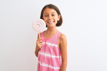 Beautiful child girl eating sweet lollipop standing over isolated white background with a happy face standing and smiling with a confident smile showing teeth
