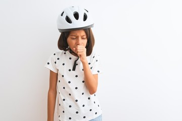 Beautiful child girl wearing security bike helmet standing over isolated white background feeling unwell and coughing as symptom for cold or bronchitis. Healthcare concept.