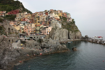 Fototapeta na wymiar Monterosso village of the Cinque Terre of Liguria with houses perched on the cliff