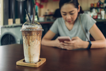 Woman is using smartphone in the coffee cafe.