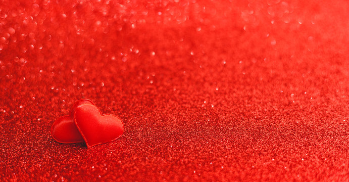 Two red hearts on a red background of sparkles. Valentines day, love, romance, dating concept, long banner with Copy space. Stock photo Valentine day card.