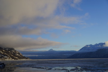 Fototapeta na wymiar Turnagain Arm Alaska view of inlet snow and ice covered mountains with cloud bank