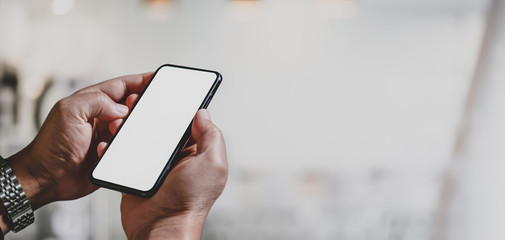 Close-up view of businesswoman holding blank screen smartphone