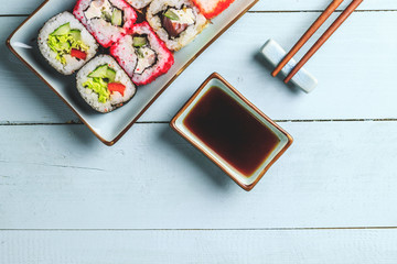 japanese sushi food. Rolls with tuna, salmon, shrimp, crab and vegetables. Top view of assorted sushi. Rainbow sushi roll on wooden background. Flat lay