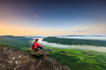 Obraz premium The girl in red jacket touring on the mountain, Phu-E-Lerd, Loei province, Thailand.