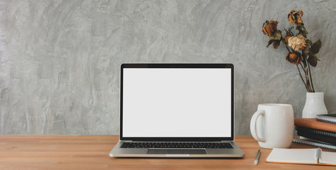 Cropped shot of trendy workplace with mock-up laptop computer and office supplies on wooden table...