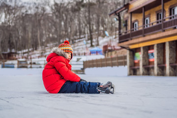 Fototapeta na wymiar Boy ice skating for the first time