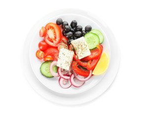Plate with fresh Greek salad on white background