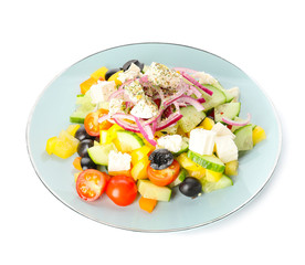 Plate with fresh Greek salad on white background