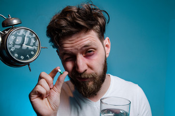 Man taking sleeping pill with glass of water 