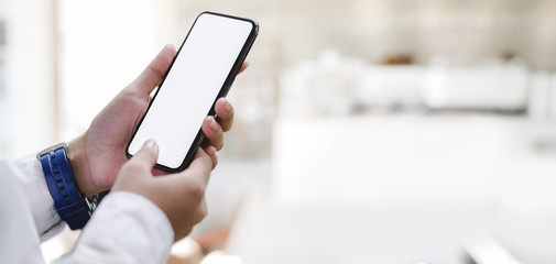 Cropped shot of young businesswoman working on her project while using smartphone