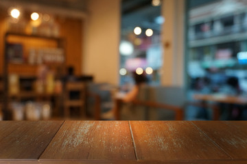 Empty dark wooden table in front of abstract blurred bokeh background of restaurant . can be used for display or montage your products.Mock up for space.