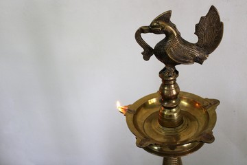 Traditional oil lamp on light background.Nilavilakku