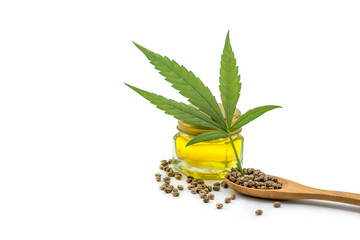 Hemp oil in a glass bottle. Hemp seeds in a wooden spoon and hemp leaves are placed on the table. The idea of extracting marijuana leaves as oil for natural diseases treatment.Natural herbal medicine.