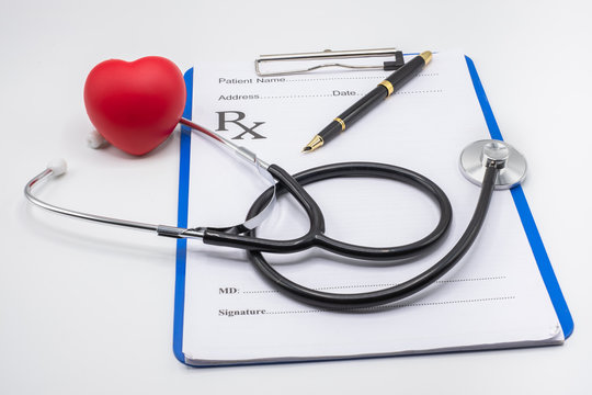 Red heart medical stethoscope and black pen Put on the doctor's charging plate.Health examination concept Health insurance. Medical health. Taking care of yourself as ordered by a doctor.Close up.