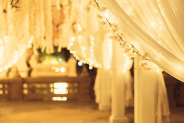 White flowers, and curtain with lighting in wedding ceremony, night outdoor theme.