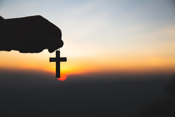 The hand holding the cross.The symbol of the blessing of Jesus.A symbol of pleading and faith.The symbol of the cross with the sunshine in the sky. Have space to enter text.