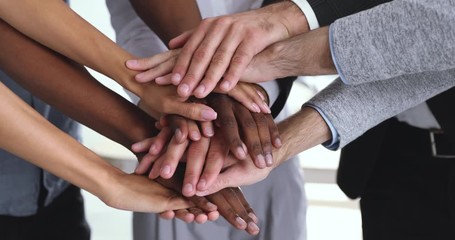 Corporate business team people stack hands together in pile, closeup
