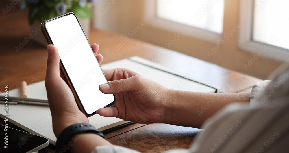 Poster cropped shot view of woman hands holding smart phone with blank copy space screen for your text mess