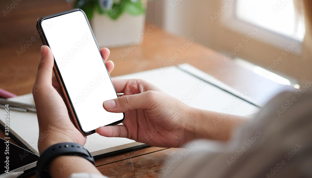 Poster cropped shot view of woman hands holding smart phone with blank copy space screen for your text mess