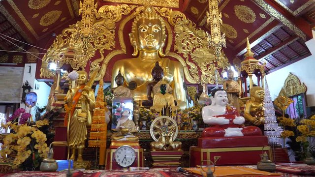 The main shrine of Buddha plus statues at a Buddhist Temple in Chiang Rai, Thailand. 4K wide.