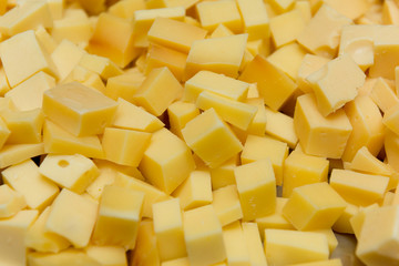 Close up of diced cheese to be served at party. Cheese seasoned with oregano, salt and olive oil. Delightful to be enjoyed and accompanied by beer. Selective focus.