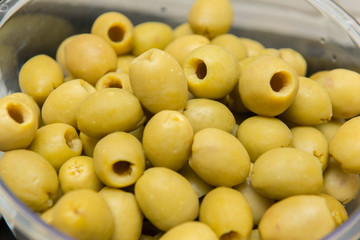 Closeup of pitted olives to be served and eaten by guests. A great taste that is usually accompanied by a beer. Selective focus.