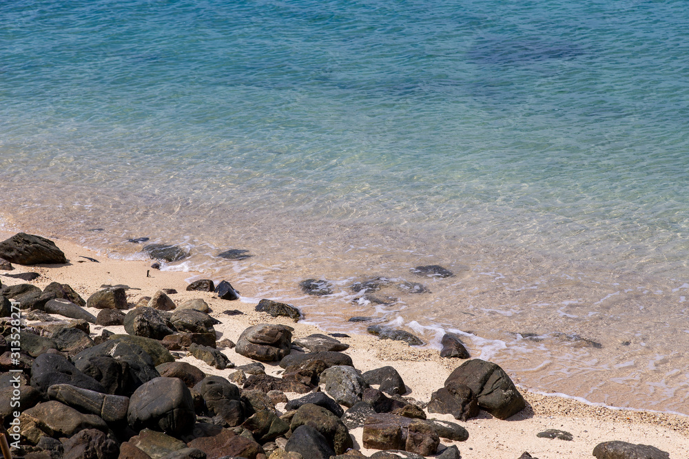 Wall mural Stones and sand at the coast