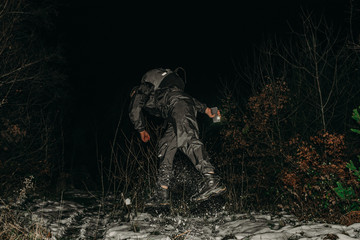 Obraz premium Male hikers in clothes for hiking and flashlights on winter mountain at night.