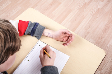 Student cheating on test with answers written on his arm
