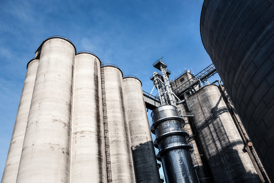 Old Grain Elevator Silos Against A Blue Sky