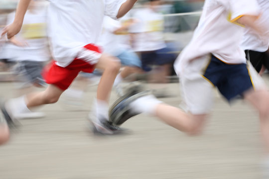 Children running a marathon, motion blurred image