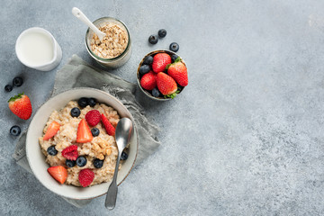 Oatmeal porridge with berries top view. Healthy breakfast food. Clean eating, dieting concept