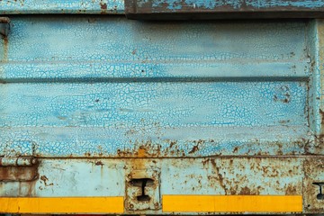 Close-up, the surface texture of the truck's metal panel is full of rust and crack