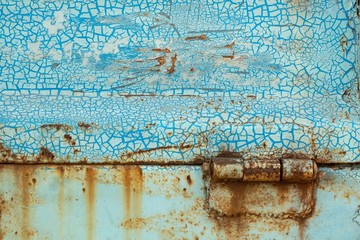 Close-up, the surface texture of the truck's metal panel is full of rust and crack