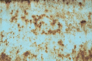 Close-up, the surface of the truck's metal panel is full of rust