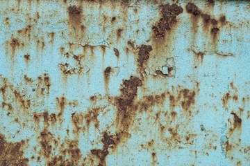 Close-up, the surface of the truck's metal panel is full of rust