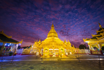 The golden stupa in Kuthodaw Pagoda,  Kuthodaw is a Buddhist stupa, located in Mandalay, Burma (Myanmar) with twilight sky background.